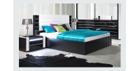 Lit double 180 cm avec option coffre LINA. Coloris noir et blanc brillant avec une finition en simili cuir. Sommier inclus