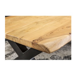 Zoom sur le coin du plateau de la table basse ARKAYA en acacia 110cm avec pieds en forme de X noirs